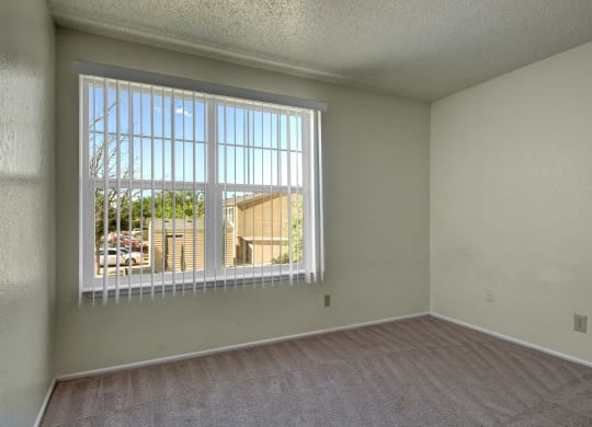 an empty living room with a large window