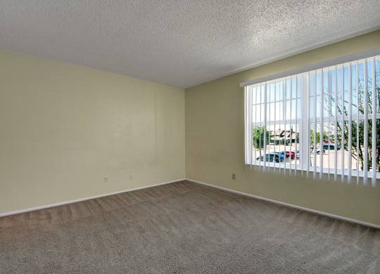 an empty living room with a large window