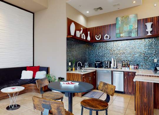 A kitchen with a table and chairs in the middle of it.