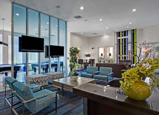 A modern living room with a pool table and a television.