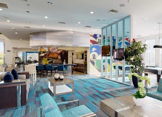 A modern living room with a blue carpet and furniture.