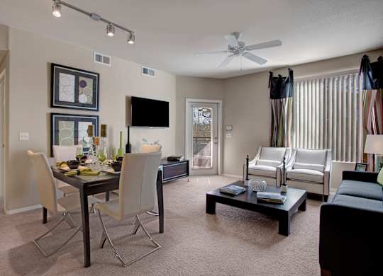 A living room with a dining table and chairs.
