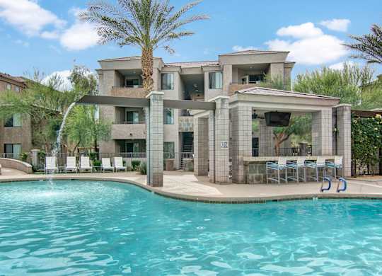 A modern house with a pool in the foreground.