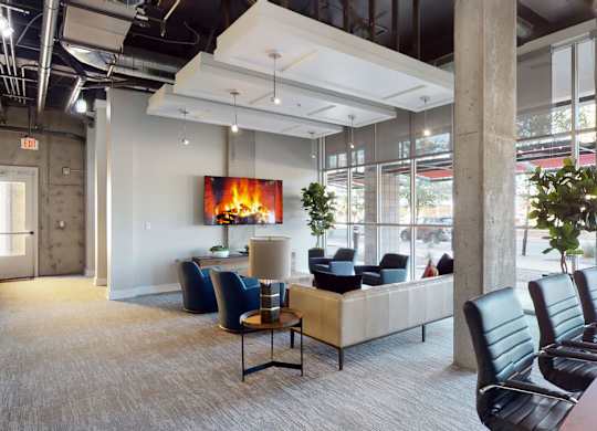 A modern waiting room with a fireplace and comfortable seating.