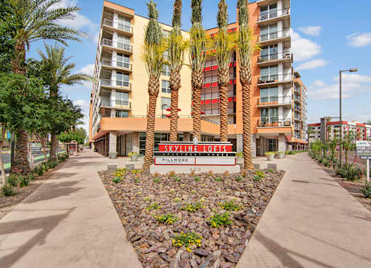 A building with a red and white sign that says Skyline Lofts.