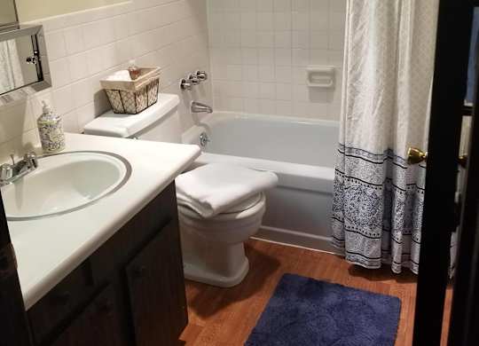 A bathroom with a white tub and a white toilet.