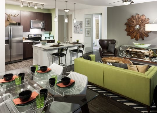 a living room and kitchen with a table and chairs