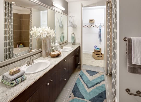 a bathroom with two sinks and a shower
