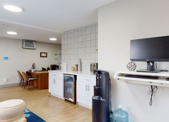 a room with a television and a kitchenette