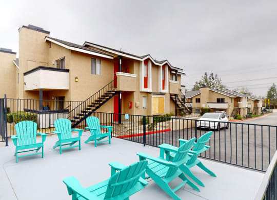 a patio with chairs and a grill at the villas at houston levee west apartments