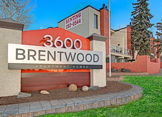 A sign for Brentwood Apartment Homes with a phone number for renting.
