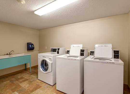 A convenient laundry room at Lakewood Heights featuring on-site washers and dryers, bright overhead lighting, durable flooring, and a functional layout that makes everyday chores simple and stress-free.