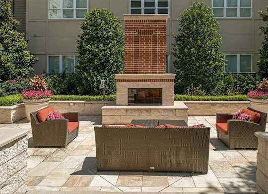 A patio with a fireplace and seating area.