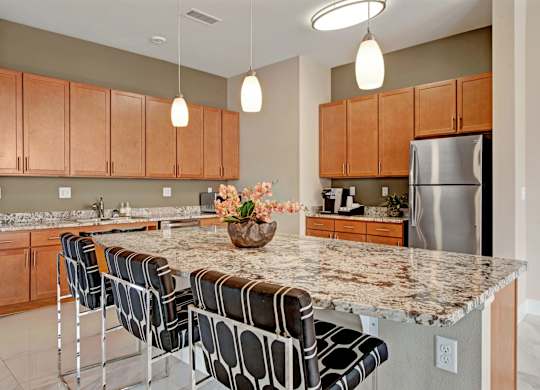 A kitchen with a granite countertop and a bowl of flowers on it.
