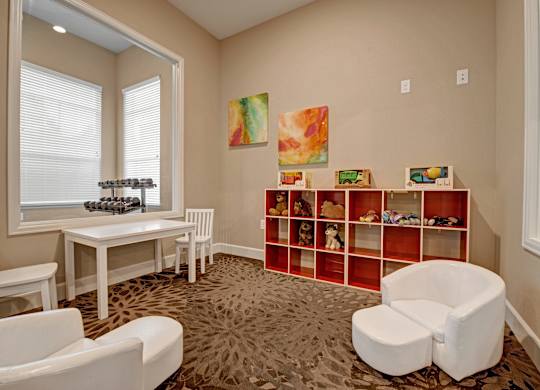 A room with a white chair, a white table, and a white bench.