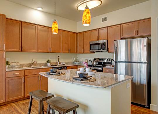 A kitchen with wooden cabinets and a granite countertop.