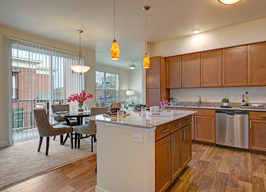 A kitchen with wooden cabinets and a white island.