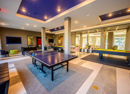 game room with ping pong table in the center of the lobby of a