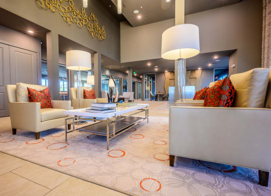 a living room with couches chairs and lamps and a rug