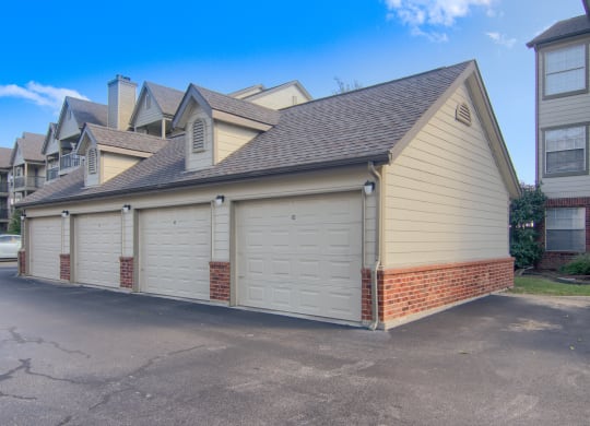 a garage with three garages on the side of the house