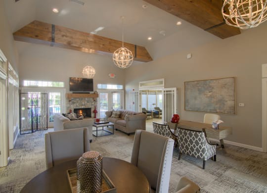 a large living room with a table and chairs