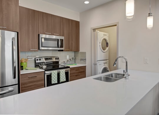 a kitchen with white countertops and wooden cabinets