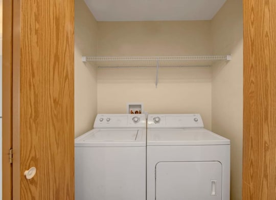 a washer and dryer in a room with a closet