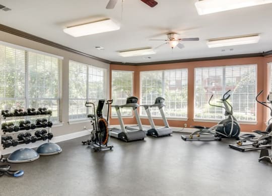 a room with a lot of exercise equipment in it