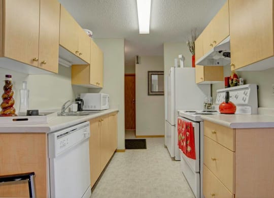 a kitchen with white appliances and wooden cabinets