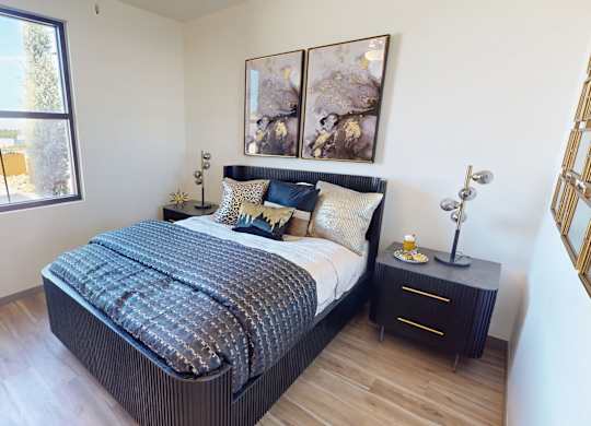 A bedroom with a large bed and a window overlooking a parking lot.