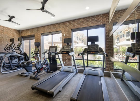 the gym at the apartments with treadmills and exercise equipment