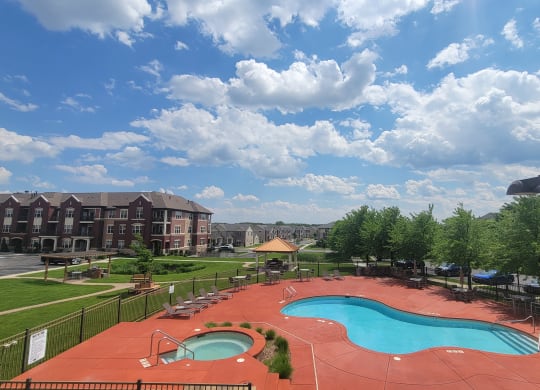 a view of a swimming pool and a resort with a building in the background