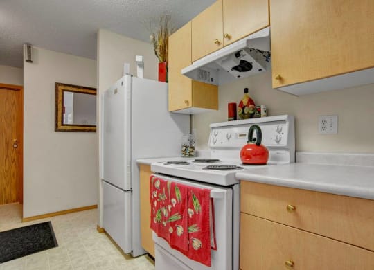 a kitchen with a white stove and a refrigerator