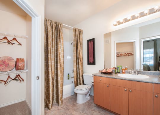 a bathroom with a shower curtain and a sink and a toilet