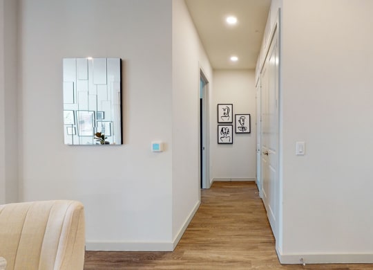 a hallway with a mirror on the wall