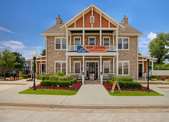 the front of the new learning center building with a sidewalk and landscaping