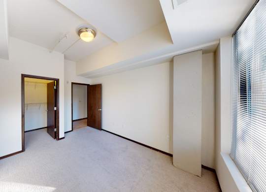 A room with white walls and a carpeted floor.