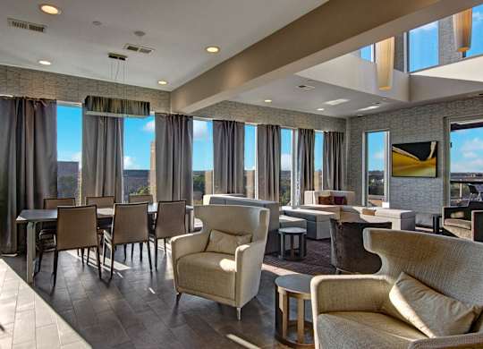 A large room with a table and chairs.