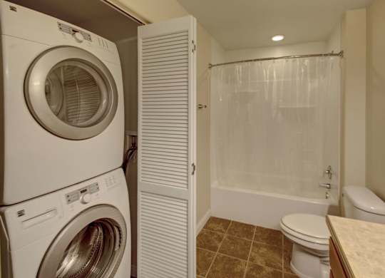 A white washer and dryer in a small laundry room.