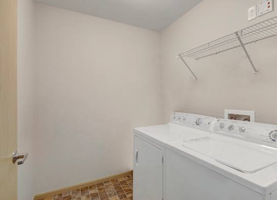 A white washer and dryer in a small laundry room.