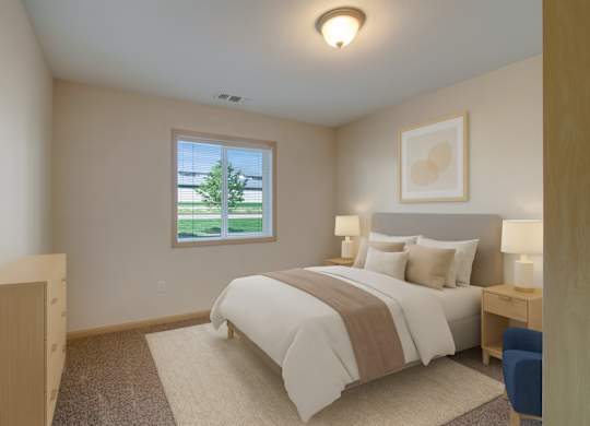 A cozy bedroom here at Pheasant Ridge featuring soft neutral walls, a queen-sized bed with white bedding and a taupe accent throw, matching bedside tables with modern lamps, a light area rug over plush carpet, minimal wall art above the headboard, and a window that brings in natural light and views of green landscaping.