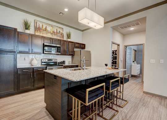 A kitchen with a bar area and a painting on the wall.