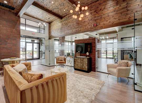 A living room with a striped couch and a wooden ceiling.