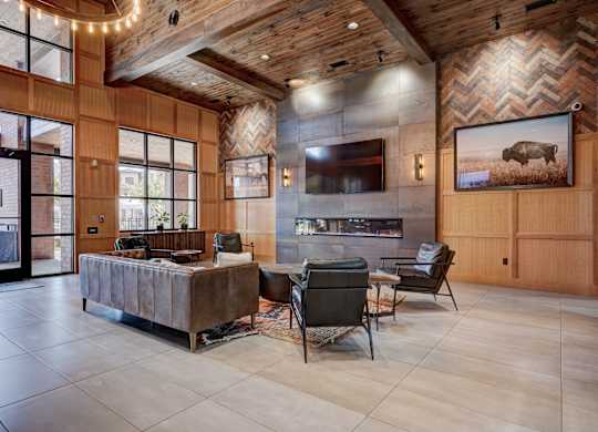 A modern living room with a wooden ceiling and a large painting of a bison.