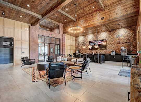 A large room with a wooden ceiling and a bar area.