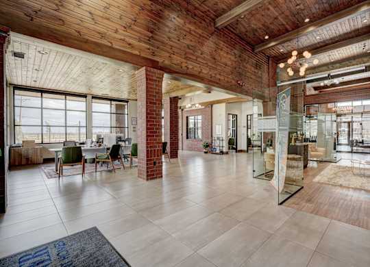 A large open space with a brick pillar and a glass wall.