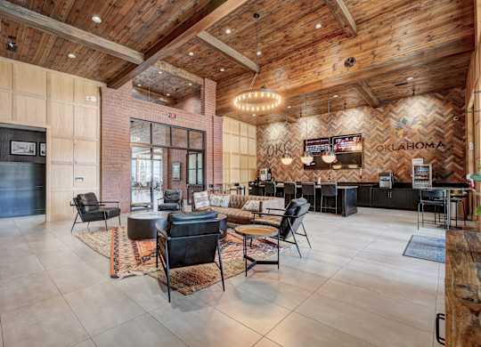 A large room with a wooden ceiling and a bar area.
