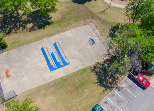 A basketball court with blue lines painted on it.