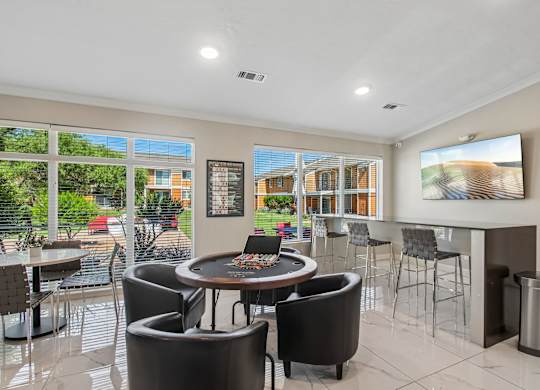A modern dining area with a round table and chairs.