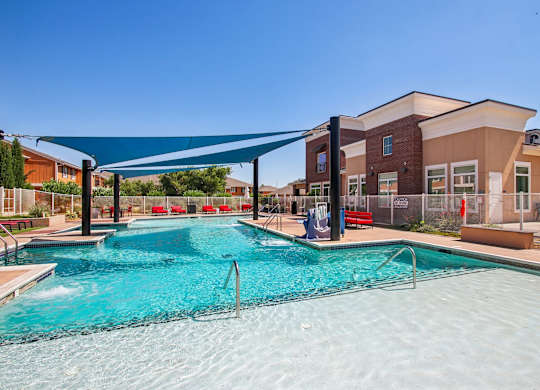 A large swimming pool with a blue tarp over it.